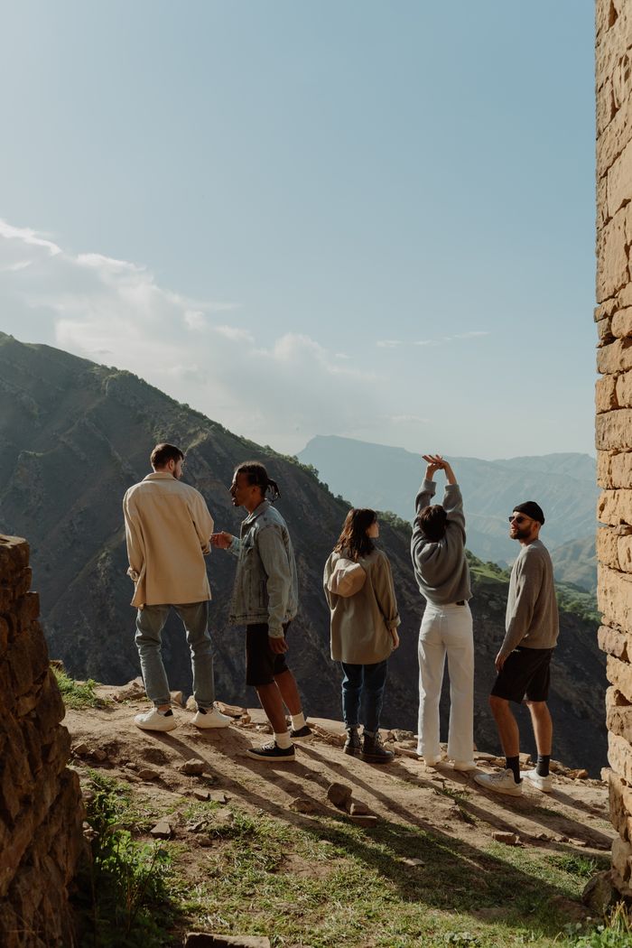 Services A group of diverse friends enjoying a scenic mountain view, showcasing their exploration and adventure spirit.